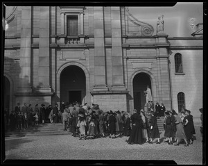 Congregation and clergy heading up the stairs into a church