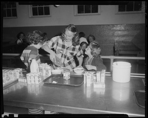 Woman and children making cereal