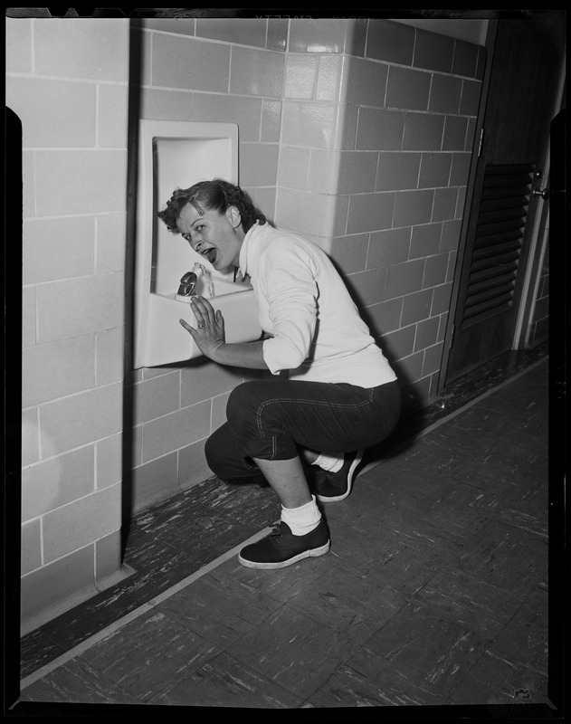 Person drinking from a water fountain