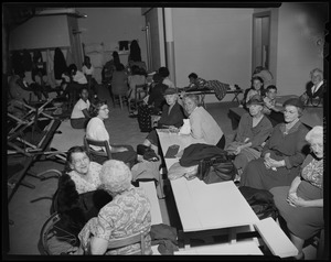 Group of women seated at a table in a shelter