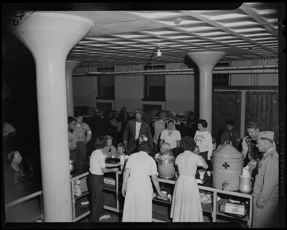 Red Cross volunteers serve a meal at a shelter