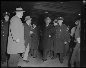 Harry S. Truman walking through crowd with police