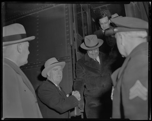 Harry S. Truman exiting train car and shaking hands