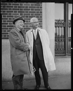 Dr. Albert B. Sabin (right) and Leo Dunphy, chapter chairman of the National Foundation shaking hands