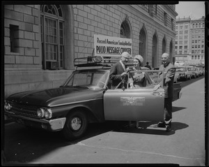 Dr. Albert B. Sabin (far left) and two others stand beside the Record American-Sunday Advertiser Polio Message Cruiser