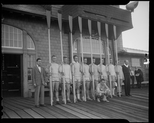 Crew team (including Gov. Leverett Saltonstall) with oars on boat dock