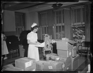 Nurse with boxes of medical supplies
