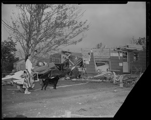 Woman with a dog near by ruined houses