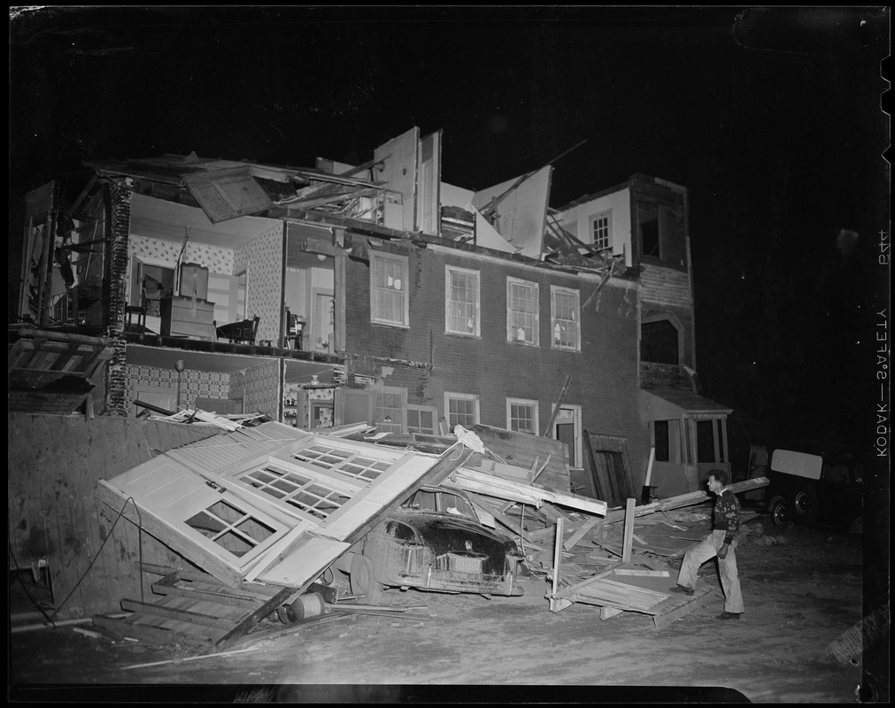 Man observing house with side blown off - Digital Commonwealth