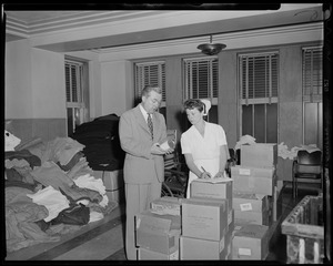 Man and woman going through supplies in boxes
