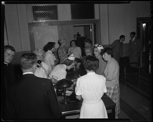 Group of people around a table checking in with a nurse