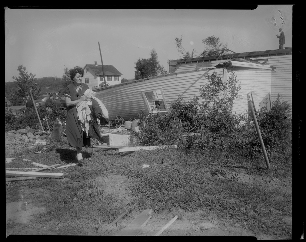 Woman and dog by ruins of house