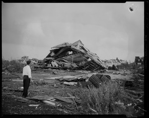 Man standing in front of a destroyed building