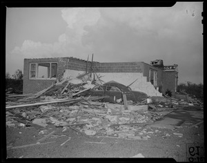 Destroyed building and parked car