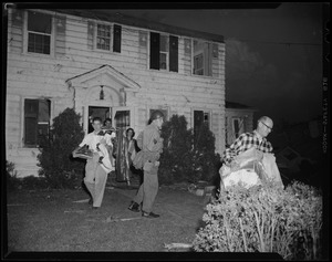 Group of people exiting a home with their belongings