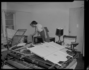 Woman looking through belongings in home