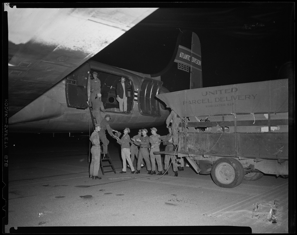 Unloading of goods from a plane, into a United parcel delivery truck