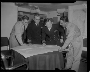 Group of four officers consulting maps