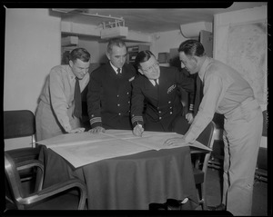 Group of four officers consulting maps