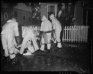 Group of six emergency workers helping a man on the ground