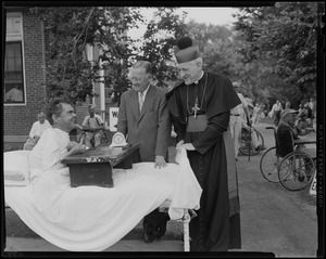 Archbishop Richard J. Cushing and Mayor Hynes visiting with a patient