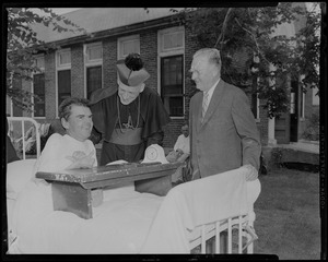 Archbishop Richard J. Cushing and Mayor Hynes visiting with a patient