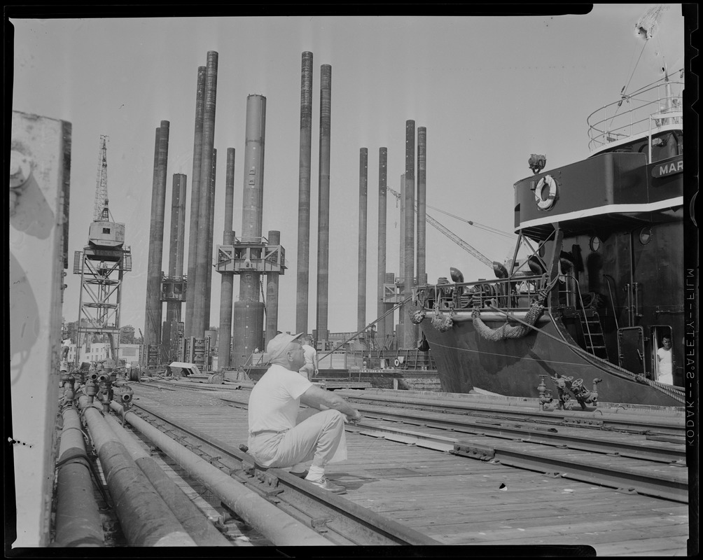 Man sitting and looking up at ship