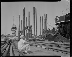 Man sitting and looking up at ship