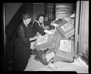 Women working with boxes of supplies for people in flooded areas