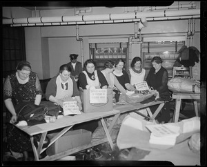 Group of workers filling boxes for flood victims