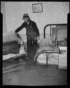 Man standing inside of a flooded house