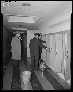 Group of men inspecting lockers
