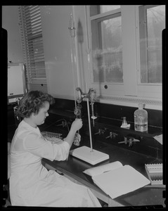 Woman in a lab holding a beaker