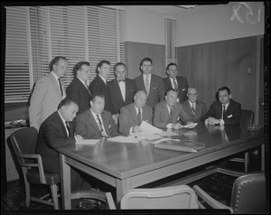 Group of twelve men sitting and standing around a table including (in front row, l. to r.): Harry Coltun, John F. Thompson, Dr. William H. Turville, Charles Gibbons, Charles Ferguson and James L. O'Dea
