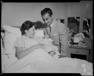 Tony DeSpirito smiling while his wife Doris holds their newborn baby