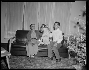 Tony DeSpirito sitting on a couch with a dog and another man