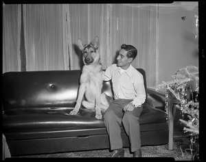 Tony DeSpirito sitting on a couch with a dog