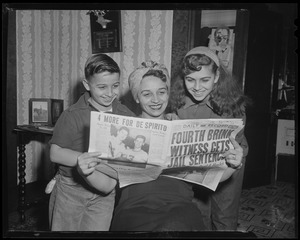 Tony DeSpirito's mother, brother Barry, and sister Barbara looking at a newspaper with the headline '4 more for De Spirito'