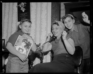 Tony DeSpirito's mother on the phone as his sister Barbara cheers and his brother Barry holds a photo