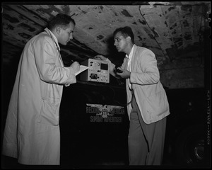 Two men using a radio instrument