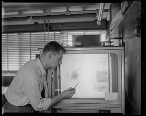 Man pointing at radar image of Hurricane Edna progress
