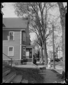 Street scene with a person pointing at tethered utility pole