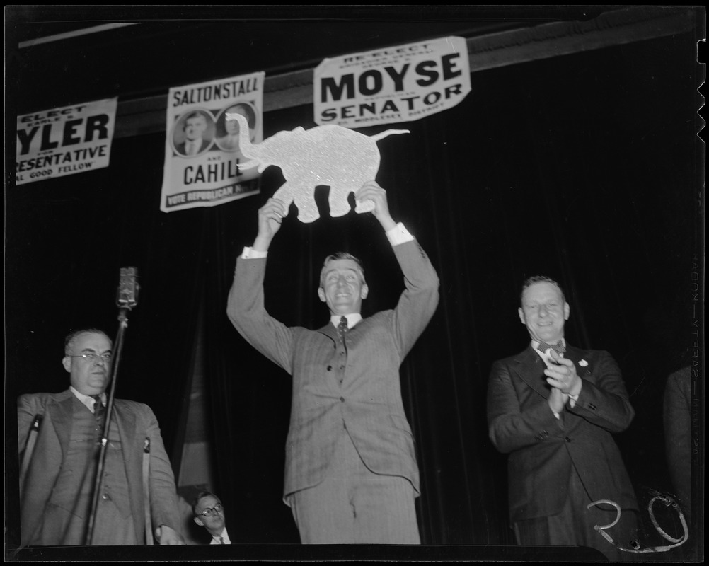 Leverett Saltonstall holding a Republican party elephant placard in above his head