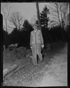 Leverett Saltonstall walking along a dirt road in a wooded area