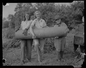 Susan Saltonstall (center) and another girl help Boy Scout carry large piece of scrap in Dover