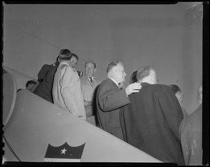 Adlai Stevenson and group of men on airplane staircase