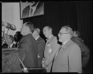Adlai Stevenson and group of men, looking off camera and seen in profile