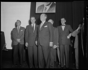 Adlai Stevenson III, Edward J. McCormack, Adlai Stevenson II and several others on stage