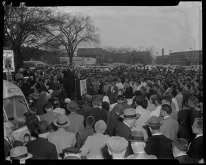 Estes Kefauver speaking at podium in front of a large crowd gathering