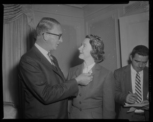 Estes Kefauver standing next to his wife Nancy and adjusting pin on her collar